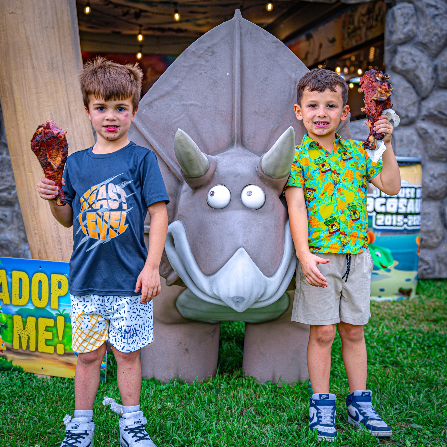 Kids with giant dino-style ribs at the 2025 House of Hogosaurus booth